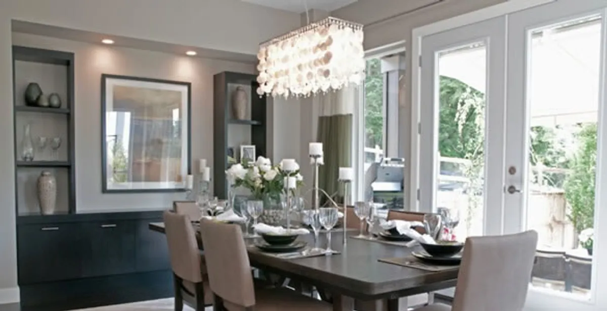 Elegant dining room chandelier installation above table in Birmingham, AL