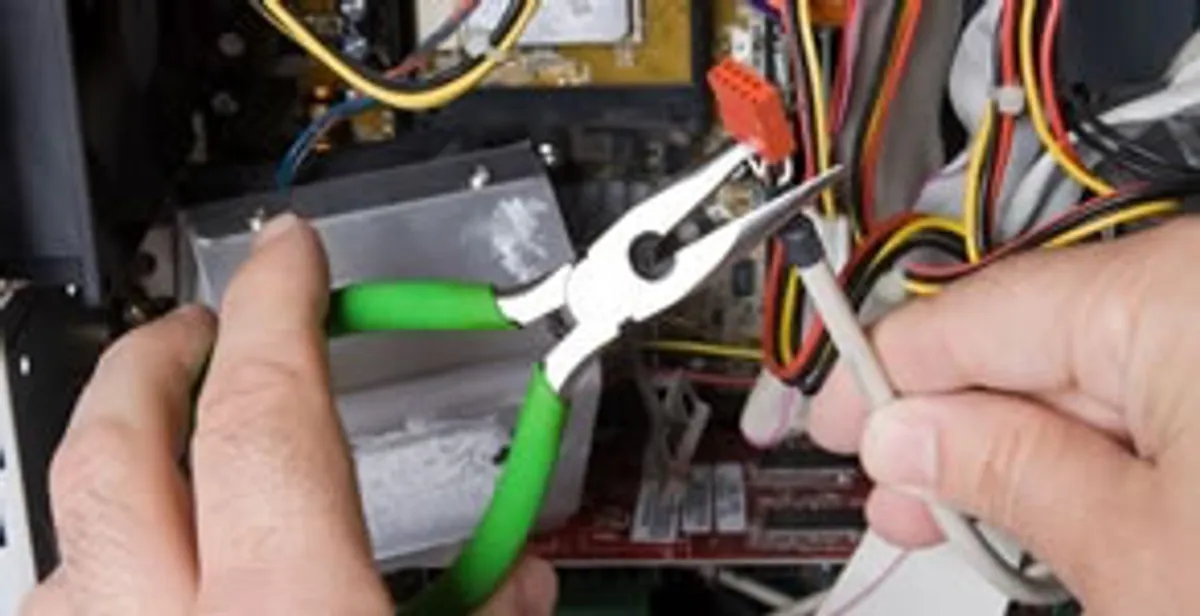 Licensed electrical contractor performing electrical repair with tools in Fultondale, AL