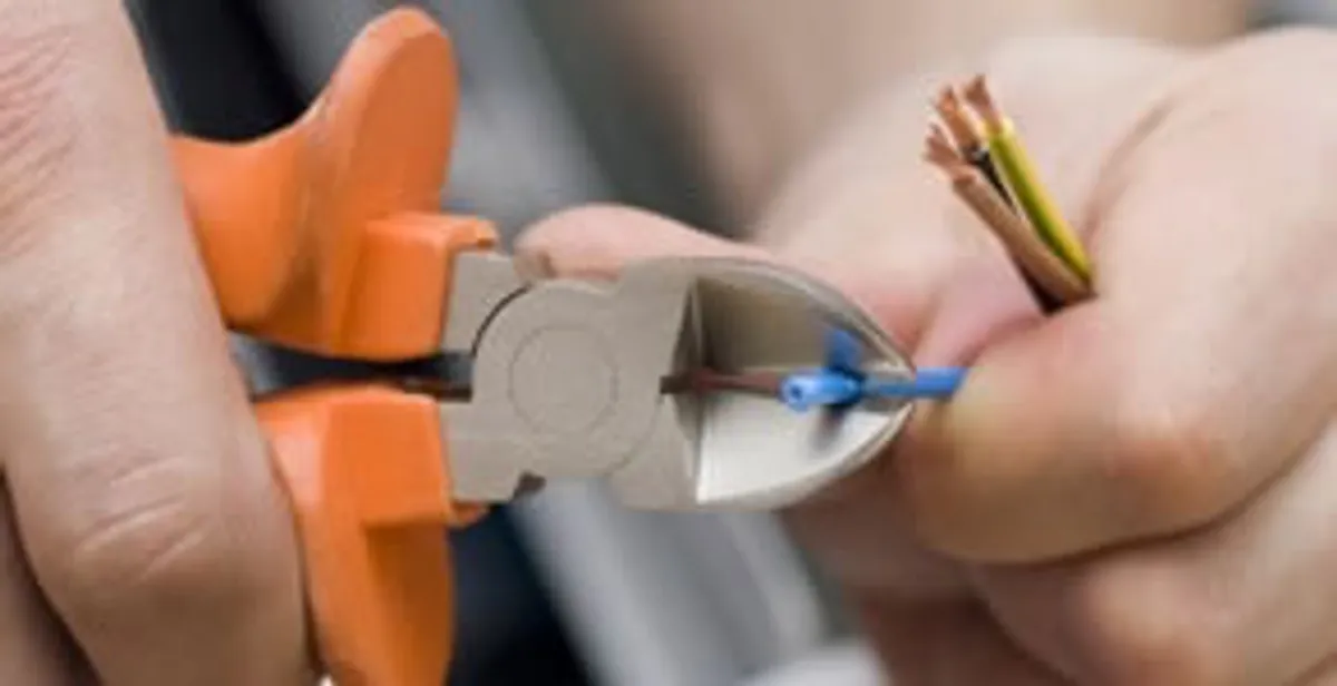 professional electrical services showing precise wire cutting by licensed electricians in Birmingham, AL